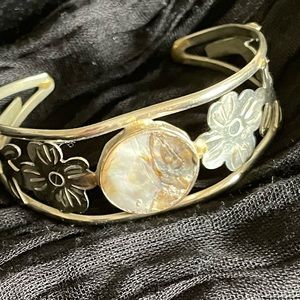 Silver bracelet with stone and etched detailing.
